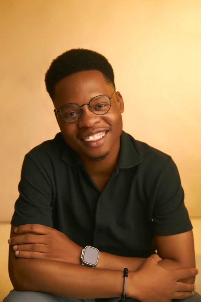 Black-and-white portrait of Adekola Emmanuel, creative director of Kolimo Multimedia